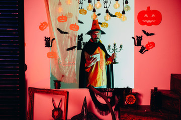 Funny wise wizard on a Halloween background. Wizard, sorcerer, warlock. Scary hipster with beard in...