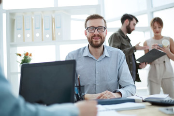 successful confident businessman sitting at his Desk