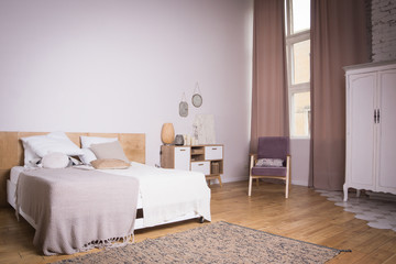 Interior of the beautiful bedroom with a vintage bed