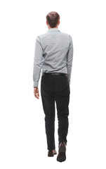 rear view. young businessman going forward.isolated on white