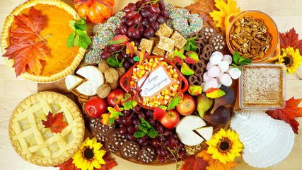 Happy Thanksgiving cheese and dessert grazing platter charcuterie board with pumpkin and apple pie.