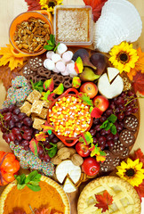 Happy Thanksgiving cheese and dessert grazing platter charcuterie board with pumpkin and apple pie.