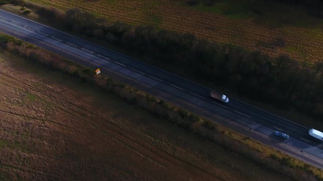 Aerial Drone Footage On Wind Turbine Renewable Green Energy Farm, Pan From Town