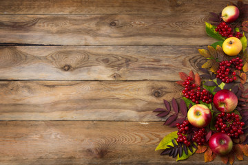 Rustic fall background with red leaves and apples