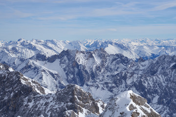Fototapeta na wymiar Alpine mountains, panoramic view from the top of the Zugspitze peak, Germany. It lies south of the town of Garmisch-Partenkirchen. 