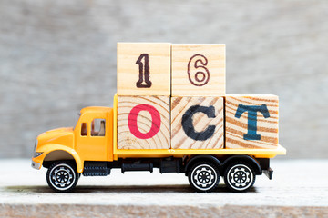 Truck hold letter block in word 16oct on wood background (Concept for date 16 month October)