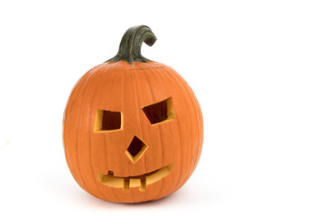 Carving a large pumpkin into a Halloween jack o'lantern isolated on white background