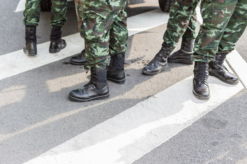 Legs of Many soldiers standing  on the road
