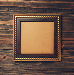 ancient style golden photo image frame on wood background
