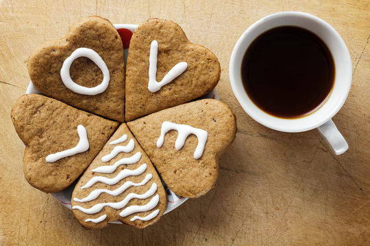 Heart shaped cookie with a cup of coffee