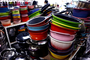 Assorted colorful ceramic and steel cooking pans