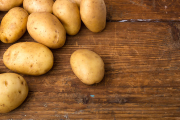 Potatoes on wood background