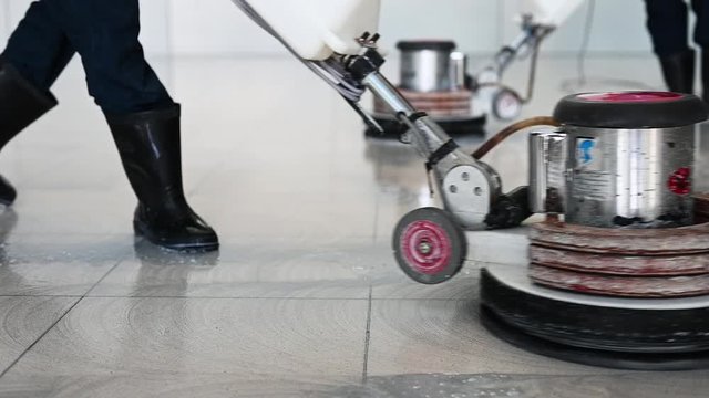 Labor cleaning the floor with cleaning machine - Slow motion