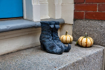witch boots and pumpkins outside . Halloween decorations on the doorstep