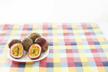 Passion fruits on tablecloth and white background