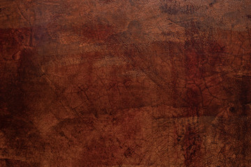 Grunge texture of a dilapidated wall in a red tone background