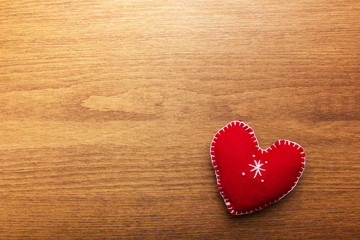 Decorative red heart on a  wooden background