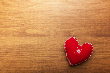 Decorative red heart on a  wooden background