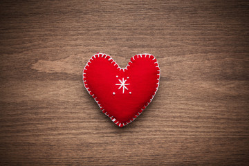 Decorative red heart on a wooden background