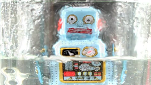 retro robot getting very  wet 
