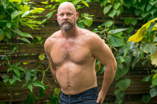 Shirtless male muscular hairy chest abs beard torn jeans
