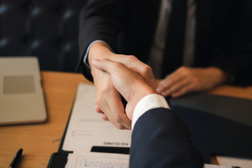 Department heads manager are shaking hands and accept to new employee in office room.