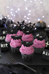 Festive Halloween cupcakes decorated with purple sweet potato fresh cream and black cocoa bat cookies