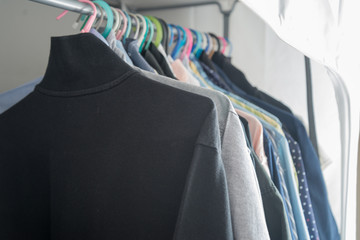 Men 's t-shirt and shirt in the closet