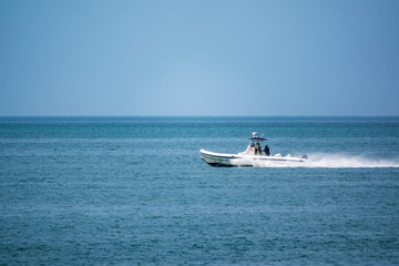 Fototapeta premium A coast guard patrol boat sails near the shore