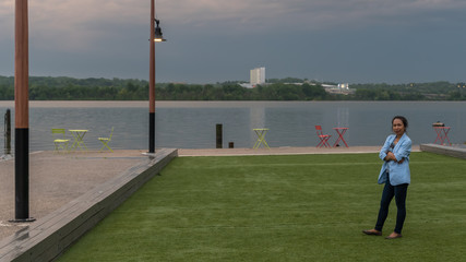 Woman in blue jacket and black pants standing in part