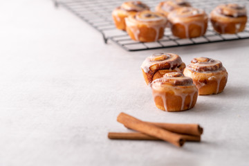 Homemade baked cinnamon rolls on cooling on cooling rack