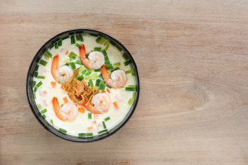 homemade style steamed egg with shrimp and vegetables in a ceramic bowl on wooden table, top view. healthy food concept.