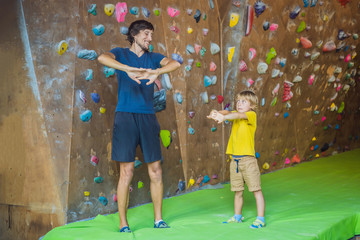 Dad and son at the climbing wall. Family sport, healthy lifestyle, happy family