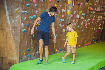 Dad and son at the climbing wall. Family sport, healthy lifestyle, happy family