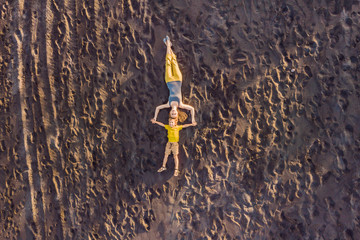 Mom and son are lying on the sand at sunset. View from the drone. Paradise, travel, vacation concept