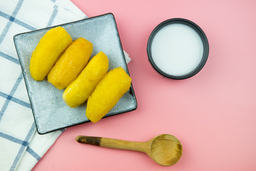 Sweet egg-banana (Pisang mas) in syrup topped coconut milk