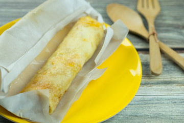 Thai sweet Roti wrap. Crispy fried dough with sugar, egg and sweet condensed milk wrapped with paper