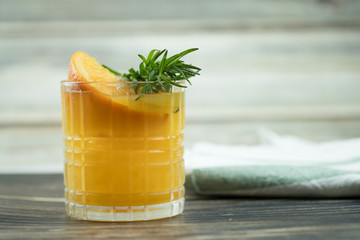 Fresh summer cocktail with orange juice and ice cubes in glass