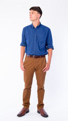 Full body shot of young handsome businessman thinking and looking away