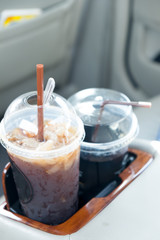 Iced coffee cup inside the car.