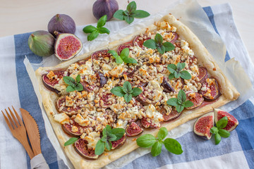 home made tart with figs and cheese on a table