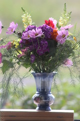 bouquet of flowers in a vase on blue background