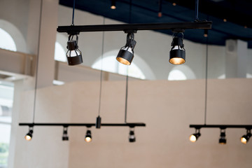 Spotlights under the ceiling on the wall.