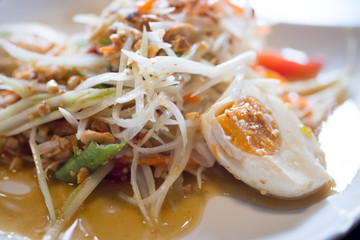 Thai spicy green papaya salad with salted egg