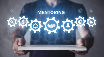 Man holding tablet with a gears mechanism. Mentoring. Business concept