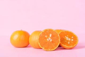 Mandarin orange fruits on pink background