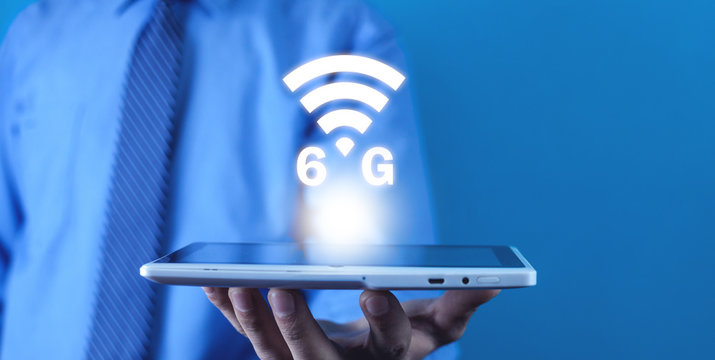 Man holding white digital tablet. Technology. 6G Network