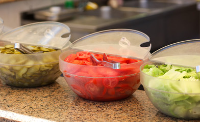 Harvesting tomato, cucumber and burger salad in the dining room
