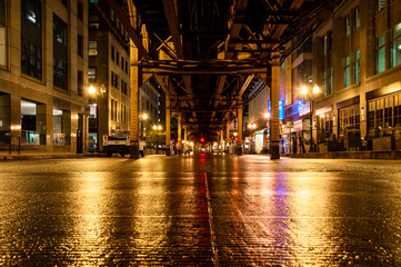 Underneath the elevated train tracks at Wells Street in the Chicago Loop at night.