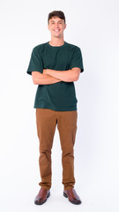 Fototapeta premium Full body shot of happy young handsome man smiling with arms crossed